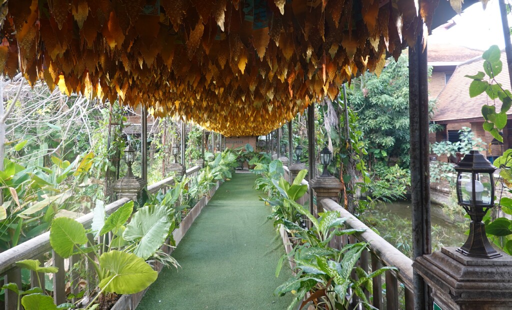 Decorated covered walkway along the lake at Wat Jed Lin, Chiang Mai, Thailand