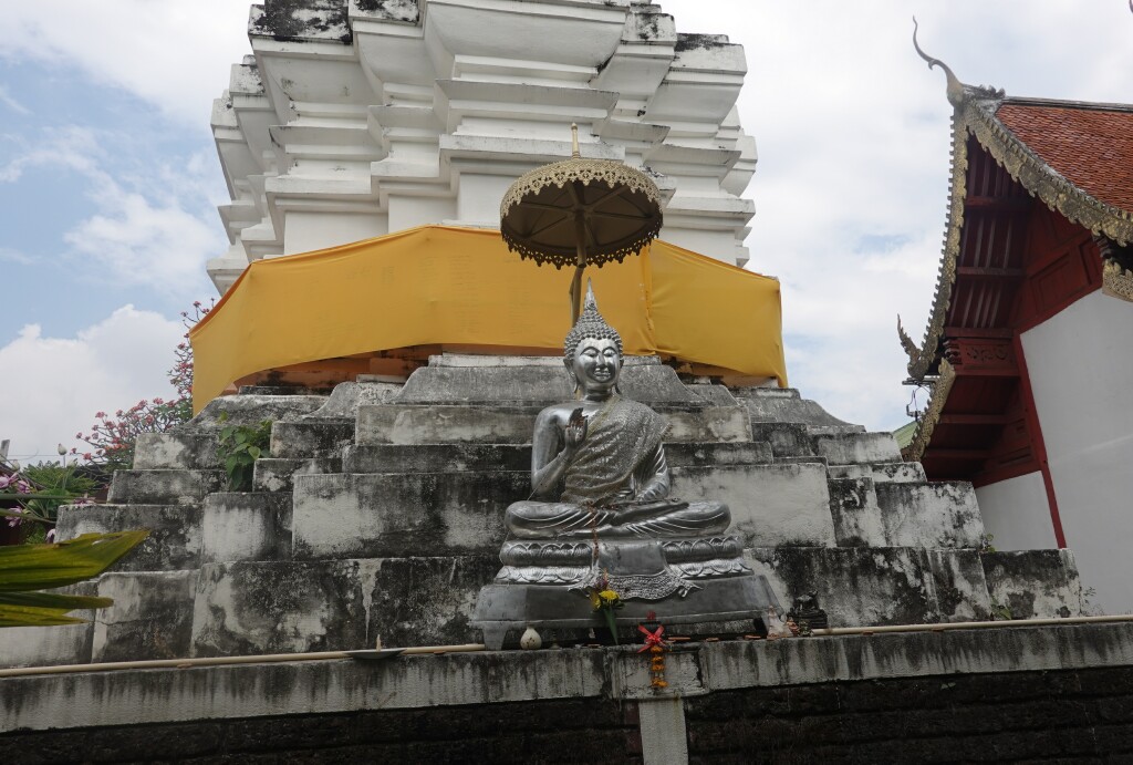 Silver Buddha beside chedi at Wat Muen Toom, Chiang Mai, Thailand