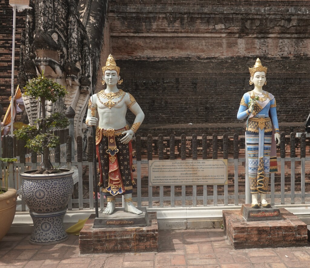 New white and colorfully dressed statues at base of chedi at Wat Chedi Luang, Chiang Mai, Thailand